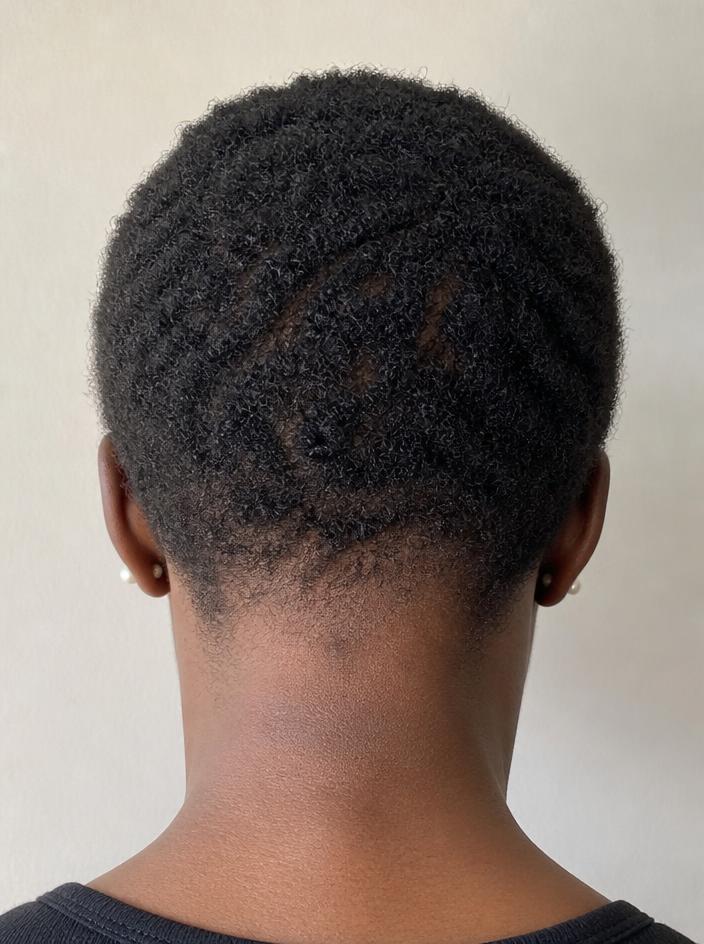 Back of a woman's head showing shorter, thinner natural hair at the start of her journey